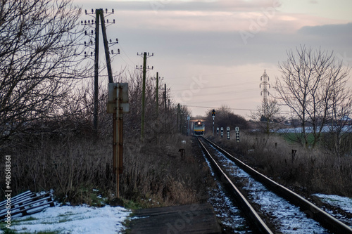 Old diesel train coming to the station in the distance winter landscape