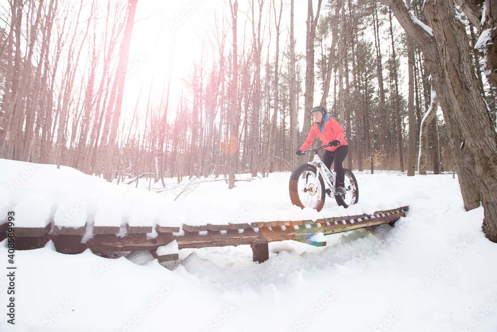 Attractive woman rides her fat bike in the snow