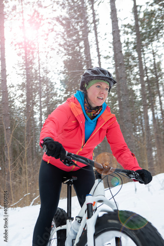 Obraz na płótnie Attractive woman rides her fat bike in the snow w salonie