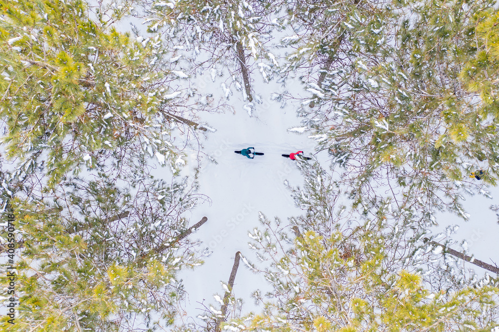 Aerial photo of a couple riding fat bikes in the snow