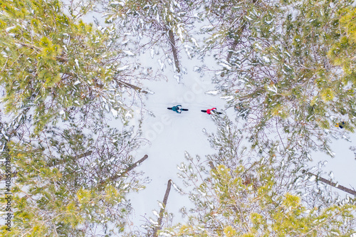 Obraz na płótnie Aerial photo of a couple riding fat bikes in the snow w salonie