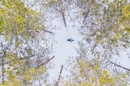 Obraz na płótnie Aerial photo of a couple riding fat bikes in the snow w salonie