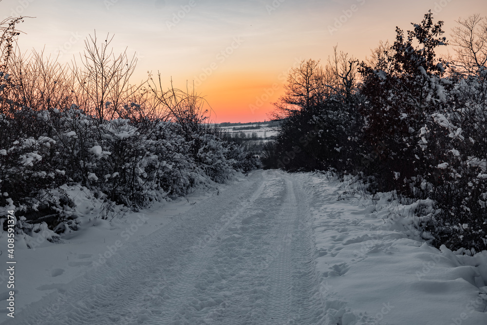  a winter road at sunset