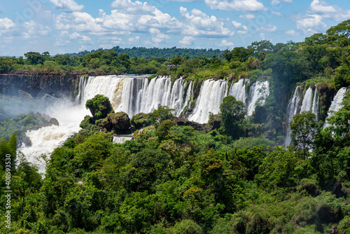 Wonderful vivid landscape of Iguazu Falls with water streams falling down among verdant vegetation