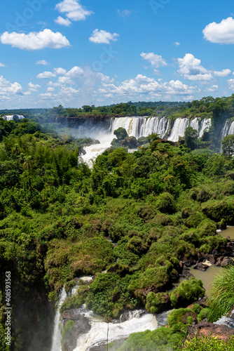 Wonderful vivid landscape of Iguazu Falls with water streams falling down among verdant vegetation