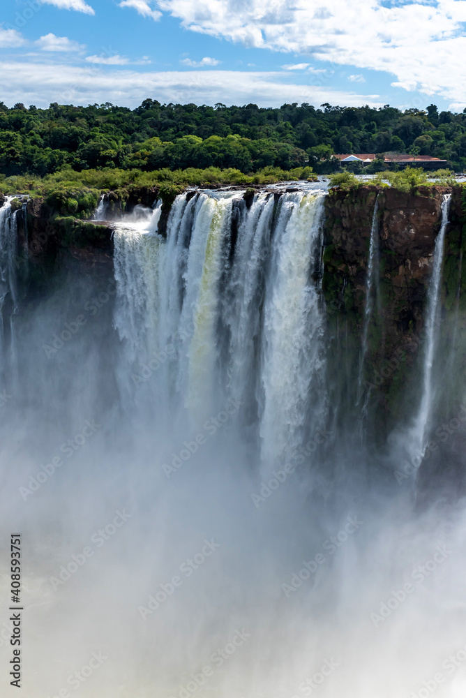 Wonderful vivid landscape of Iguazu Falls with water streams falling down among verdant vegetation in sunny day Wonderful vivid landscape of Iguazu Falls with water streams falling down among verdant vegetation in sunny day
