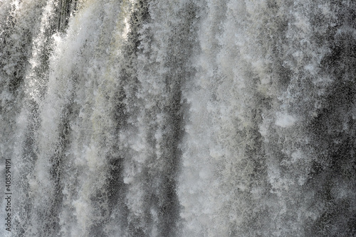 Closeup view of majestic powerful stream of Iguazu Falls