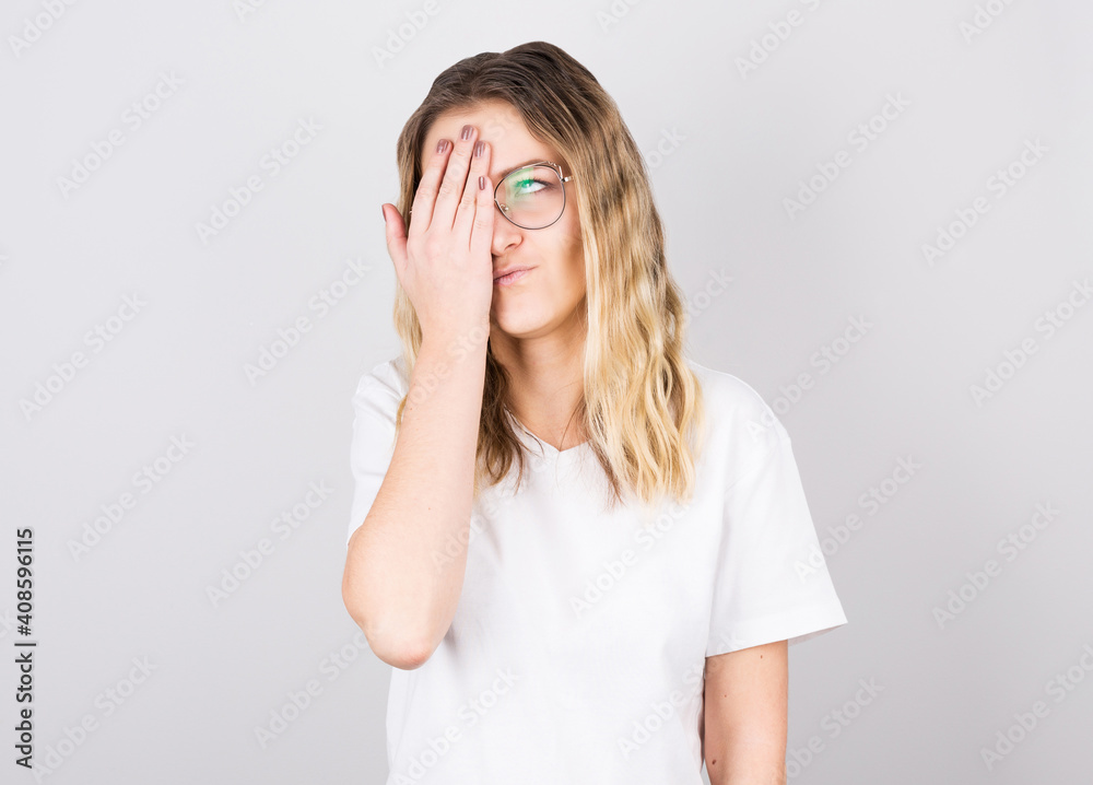Tired sleepy woman holds face with her hand, has sad expression, cannot wake up in the morning and go to work. isolated white background Tired sleepy woman holds face with her hand, has sad expression, cannot wake up in the morning and go to work. isolated white background