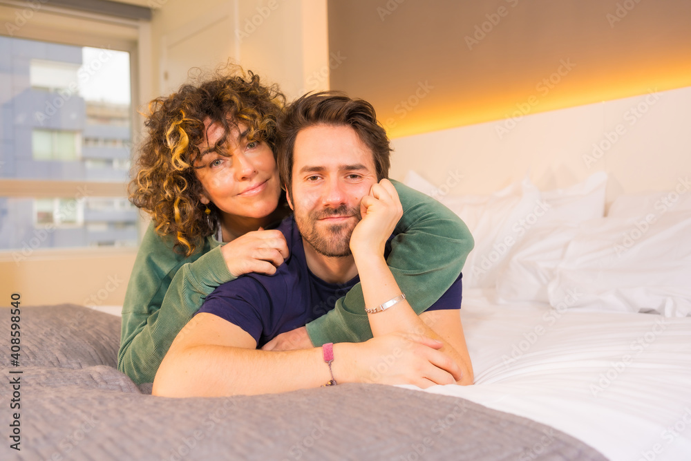 Lifestyle, portrait of a young Caucasian couple in pajamas on the bed Lifestyle, portrait of a young Caucasian couple in pajamas on the bed