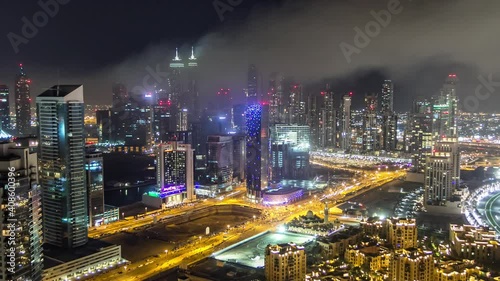 Wallpaper Mural Aerial view of a big modern city at night timelapse with night traffic and illuminated skyscrapers, office buildings. Business bay, Dubai, United Arab Emirates. Torontodigital.ca