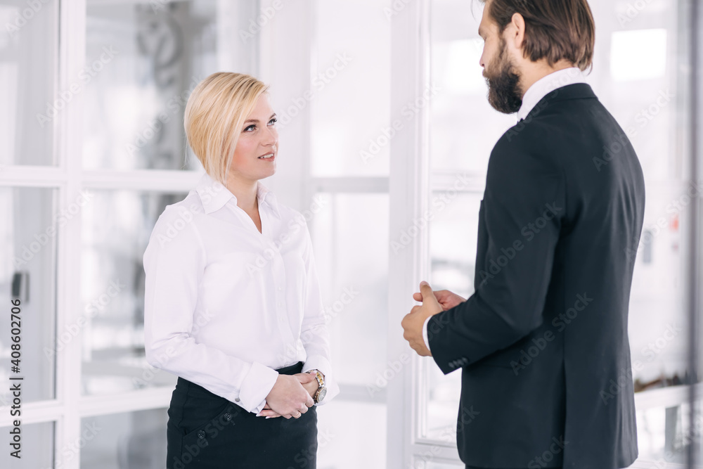 Confident business partners stand in an office building after a