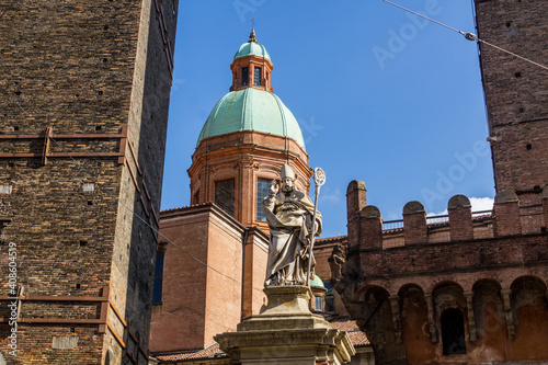 Saint Petronius statue and the Two towers in Bologna, Italy photo