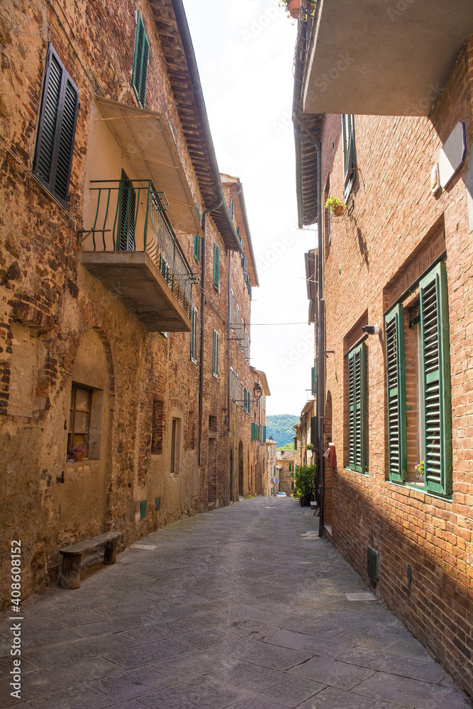 Fototapeta premium A quiet residential street in the historic centre of the medieval town of Monticiano in Siena Province, Tuscany, Italy 