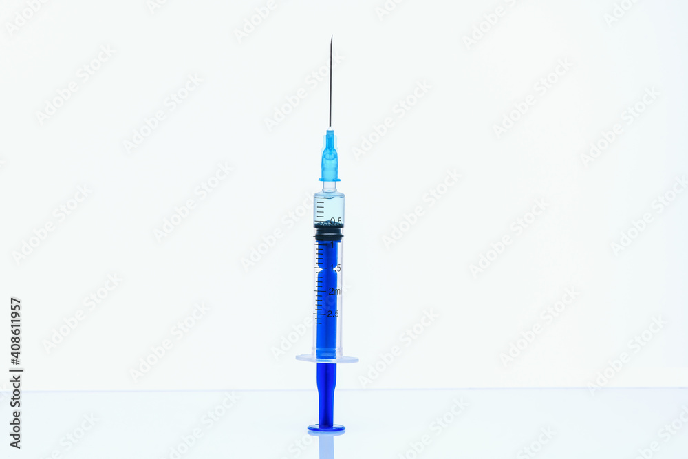A syringe with a vaccine against Coronavirus infection on a white background. The concept of protection against Coronavirus infection, COVID-19. Healthcare and medical concept. A syringe with a vaccine against Coronavirus infection on a white background. The concept of protection against Coronavirus infection, COVID-19. Healthcare and medical concept.