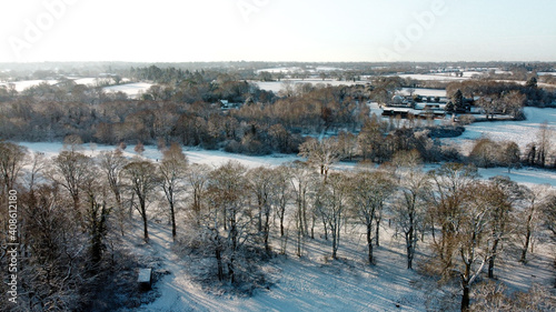 Aerial snow covered Solihull park and woodland scene, United Kingdom from drone