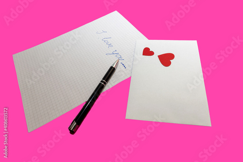 love letter, pen and envelote vith little paper hearts on pink background