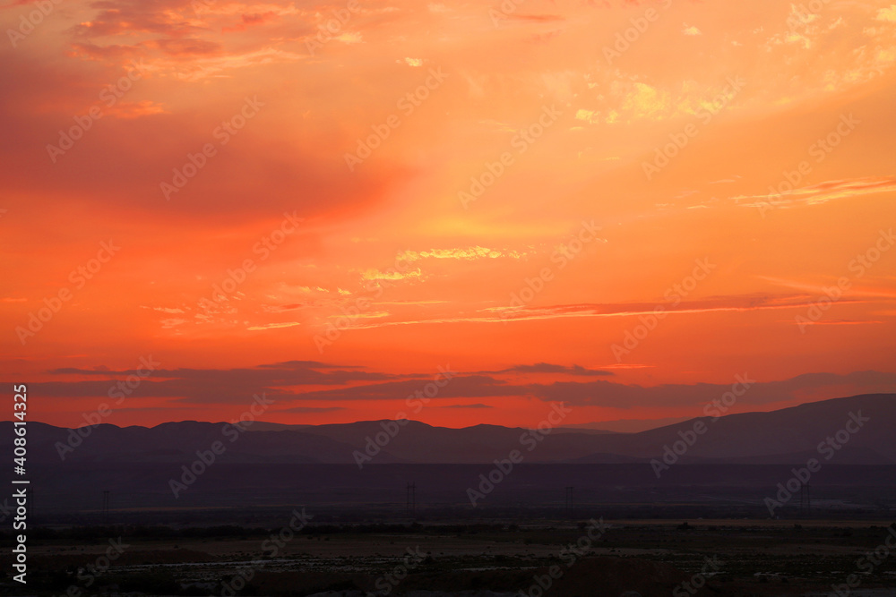 Silhouettes of mountains at sunset of the day.