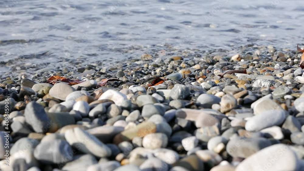 Waves calmly washing up rocky sea beach. Seashore Waves calmly washing up rocky sea beach. Seashore