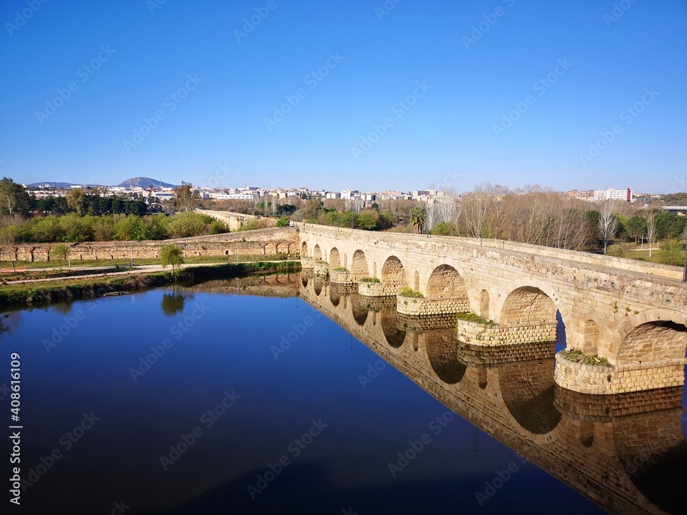 roman bridge over the river reflection in Merida Spain