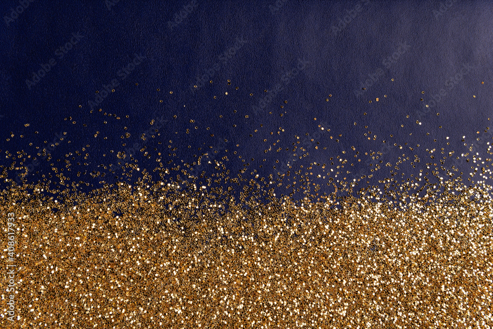 golden glitter sparkles dust texture on blue paper background
