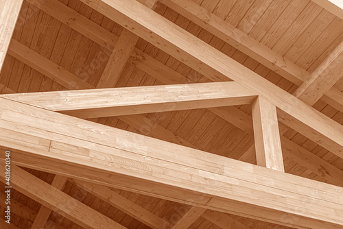 Wooden roof structure. Glued laminated timber roof. Rafters made of wood. photo