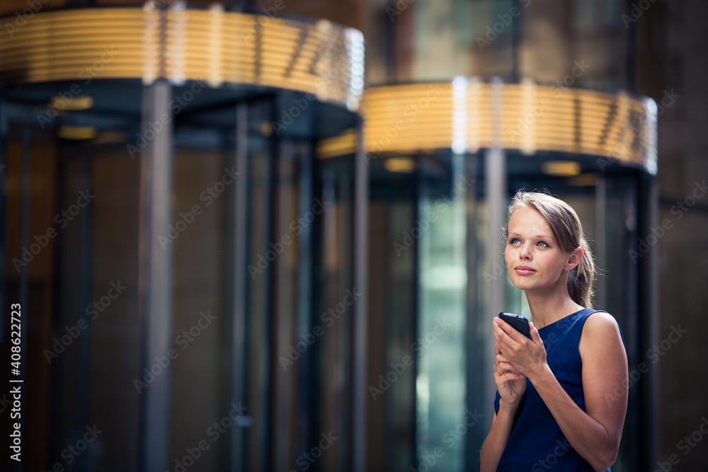 Gorgeous young businesswoman calling on her phone in front of her company's building (shallow DOF; color toned image) Gorgeous young businesswoman calling on her phone in front of her company's building (shallow DOF; color toned image)