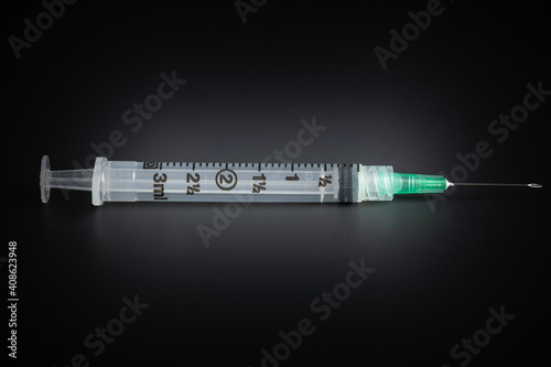 Hygienic Single-Use Disposable Syringe Injection On Black Background photo
