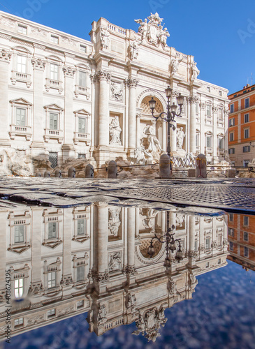 Rome, Italy - in Winter time, frequent rain showers create pools in which the wonderful Old Town of Rome reflect like in a mirror. Here in particular the Trevi Fountain