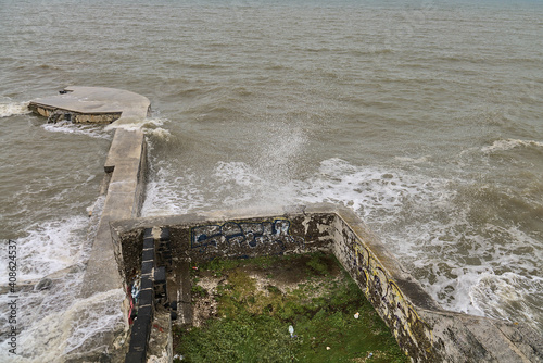 Photography Blackrock Beach during small storm pedestrian crossing bridge at Blackrock train station, Dublin, Ireland