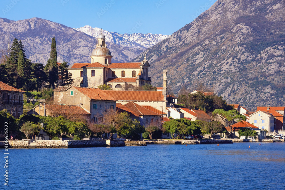 Ancient town of Prcanj on sunny winter day. Nativity of the Blessed Virgin Mary church.  Montenegro, Adriatic Sea, Bay of Kotor