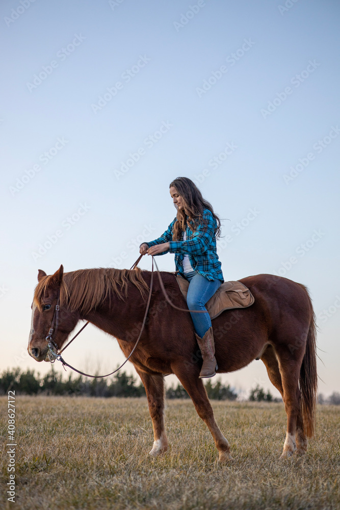 Fototapeta premium Girl in Flannel Riding Brown Horse