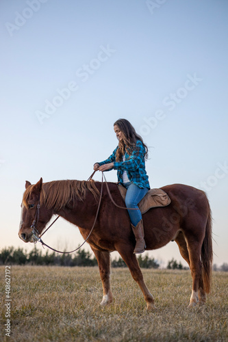 Girl in Flannel Riding Brown Horse