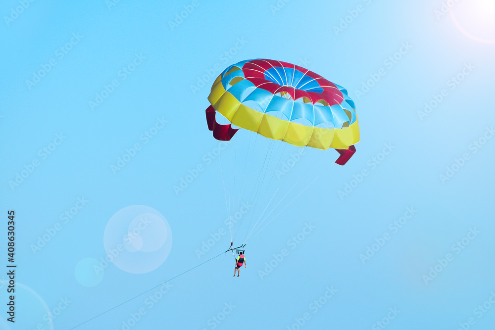 Man is fond of parasailing along sky. Free flying with parachute Man is fond of parasailing along sky. Free flying with parachute