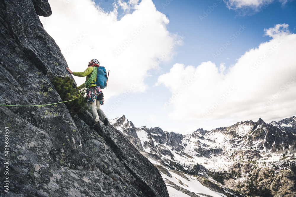 Man lead climbing on alpine rock route in Washington Man lead climbing on alpine rock route in Washington
