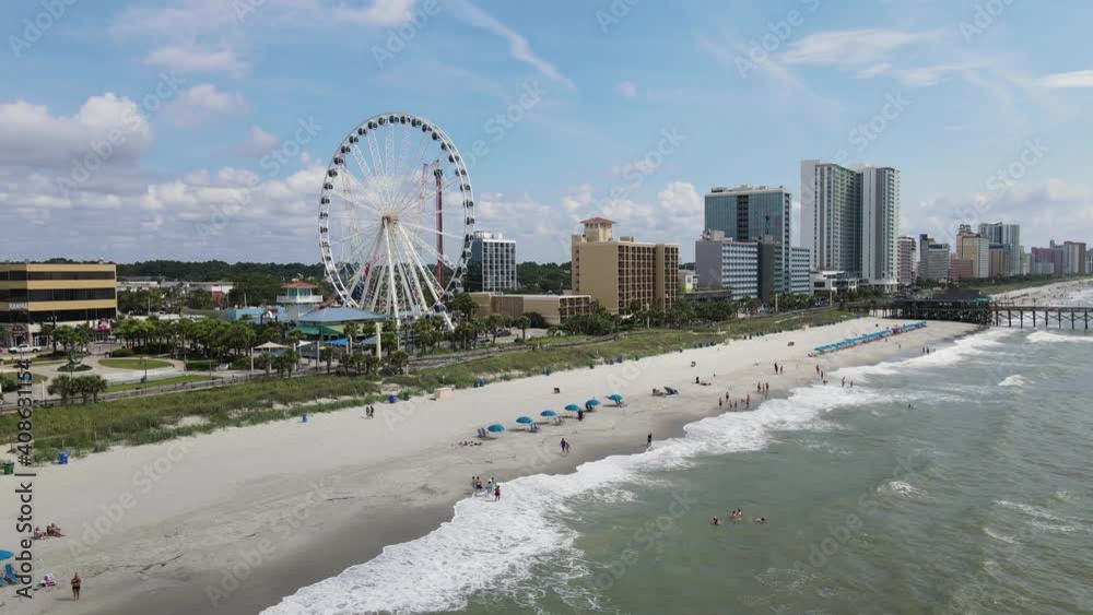 Aerial View of Myrtle Beach, Ferris Wheel, Pier and Beachfront Hotels on Summer Day, South Carolina USA. 60fps Drone Shot