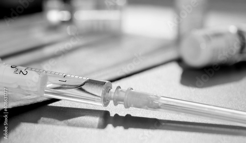 Coronavirus vaccine with syringe drugs for the design of information materials on the benefits of vaccination against viral diseases, thermometer and medical mask are the main working tools a doctor