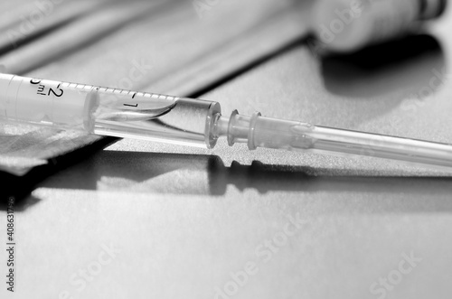 Coronavirus vaccine with syringe drugs for the design of information materials on the benefits of vaccination against viral diseases, thermometer and medical mask are the main working tools a doctor