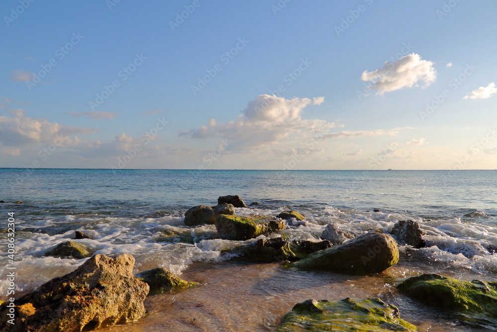 rocky landscape in front of the sea, stones on the shore of the beach during sunset on the Caribbean coast. a space to meditate and take in the ocean