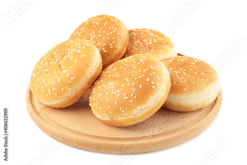 Burger buns on cutting board isolated on a white background.