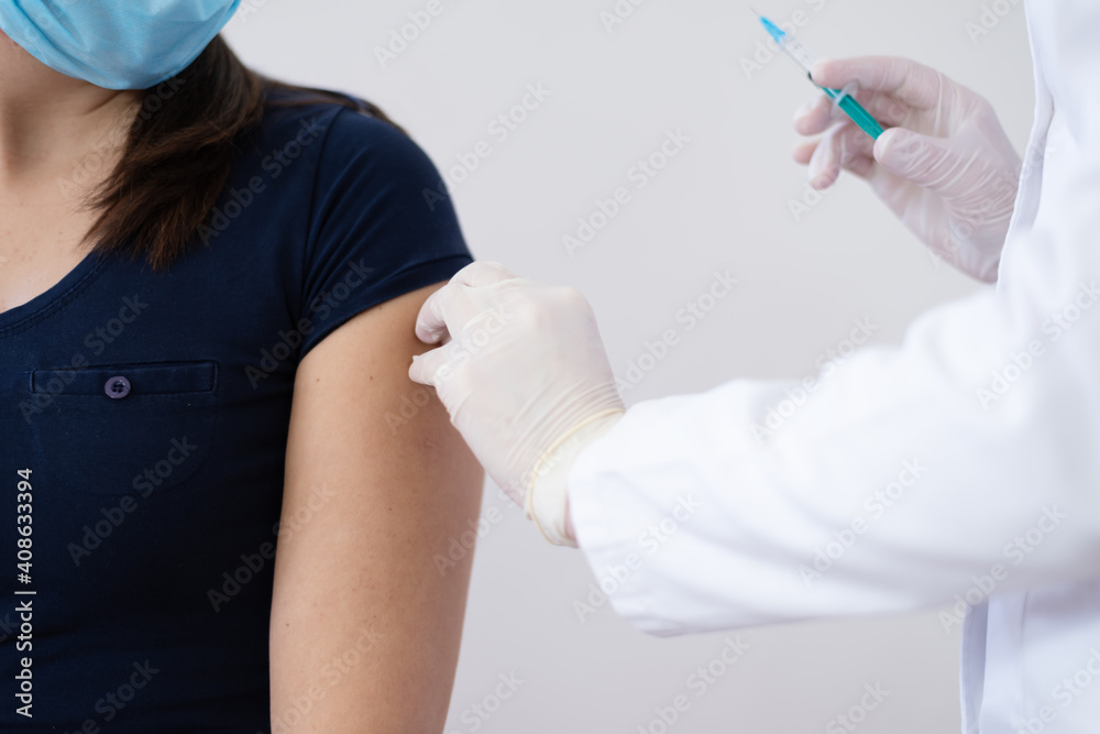 General practitioner vaccinating patient in clinic. Doctor giving injection to senior woman at hospital. Nurse holding syringe before make Covid-19 or coronavirus vaccine. General practitioner vaccinating patient in clinic. Doctor giving injection to senior woman at hospital. Nurse holding syringe before make Covid-19 or coronavirus vaccine.