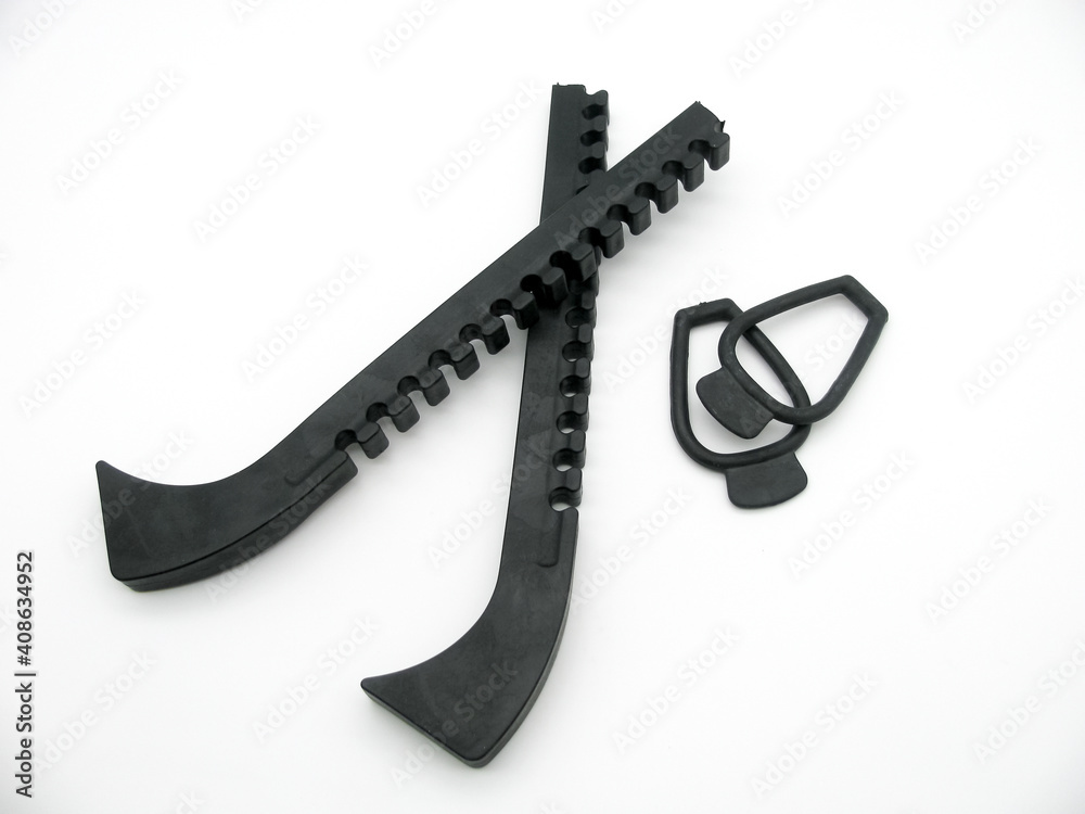 Plastic black blade guards for Figure skates on white background Plastic black blade guards for Figure skates on white background