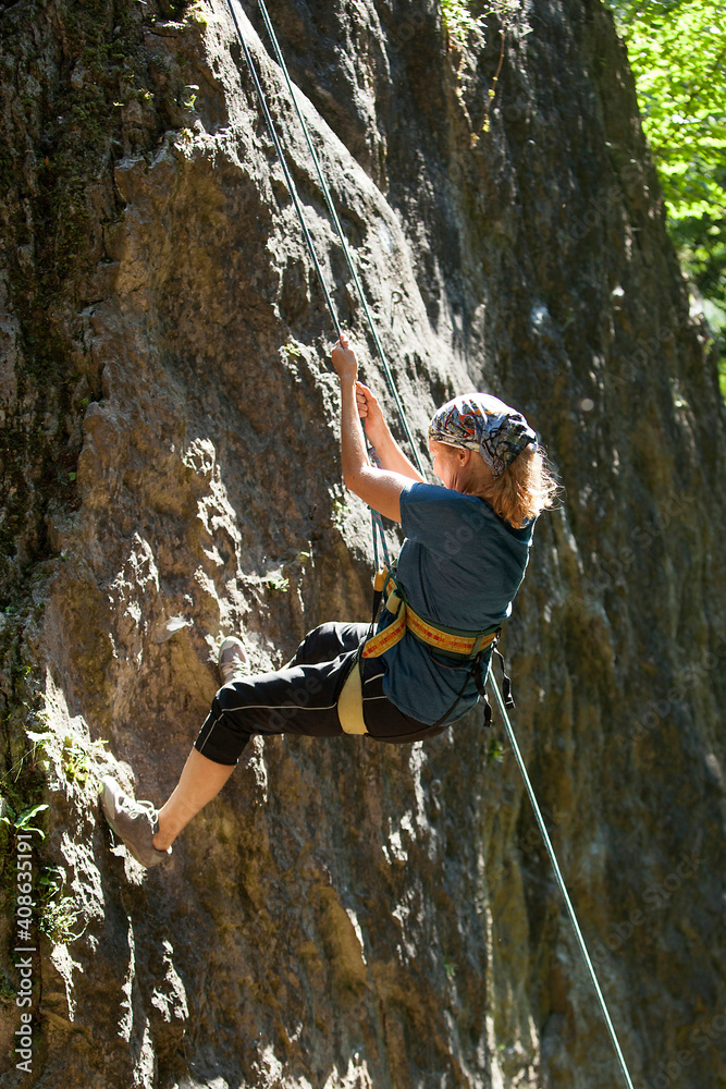 Elderly woman climbing outdoor