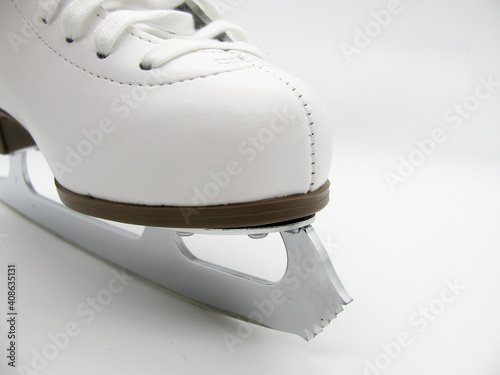 The front part of a white figure skate on a white background photo
