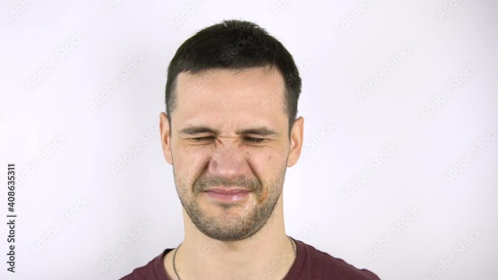 Young handsome guy gets hit in the face with a fresh fish. Young handsome guy gets hit in the face with a fresh fish.