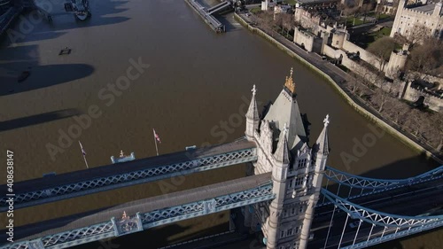 Amazing aerial view crossing the iconic tower bridge in a zenith plane and in the background the skyline and the istoric castle takem 2021 photo