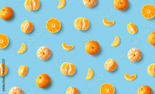 Colorful fruit pattern of fresh mandarin tangerine or clementine on blue background photo