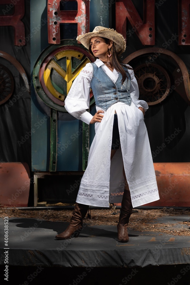 Obraz premium Beautiful Asian Indian woman in cowgirl themed fashion shoot.