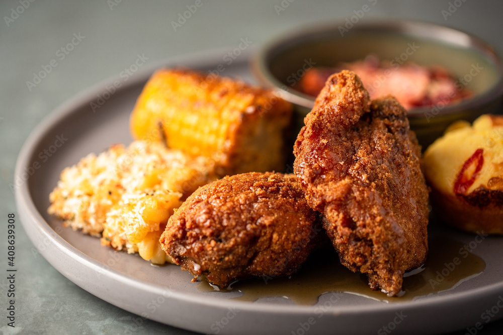 Southern fried chicken with mac and cheese, corn on the cob, coleslaw and maple syrup sauce Southern fried chicken with mac and cheese, corn on the cob, coleslaw and maple syrup sauce
