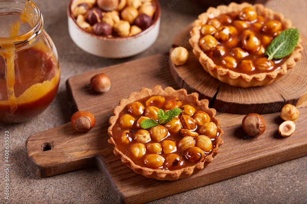 Mini tarts with nuts and caramel cream filling. Sweet homemade dessert. Mini tarts with nuts and caramel cream filling. Sweet homemade dessert.