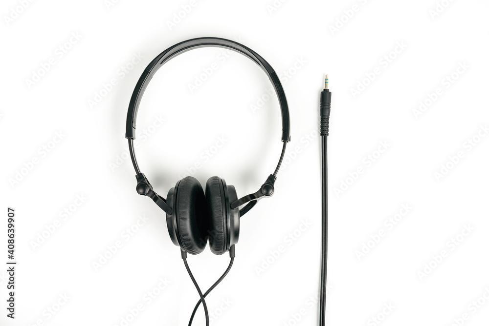 Black headphones on white background with 3,5 mm jack for plug in Black headphones on white background with 3,5 mm jack for plug in